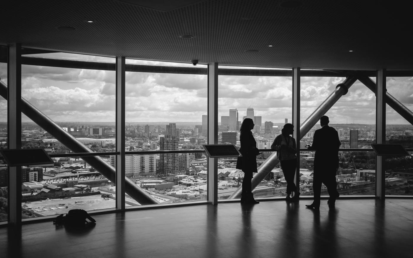 people standing inside city building by Charles Forerunner courtesy of Unsplash.
