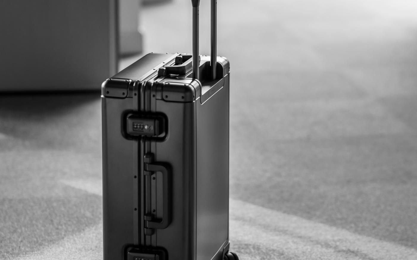 grey hard case luggage by Sun Lingyan courtesy of Unsplash.
