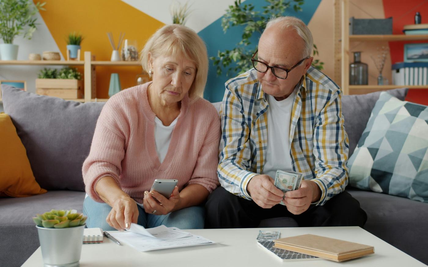 Elderly couple looking at bills and phone by Vitaly Gariev courtesy of Unsplash.