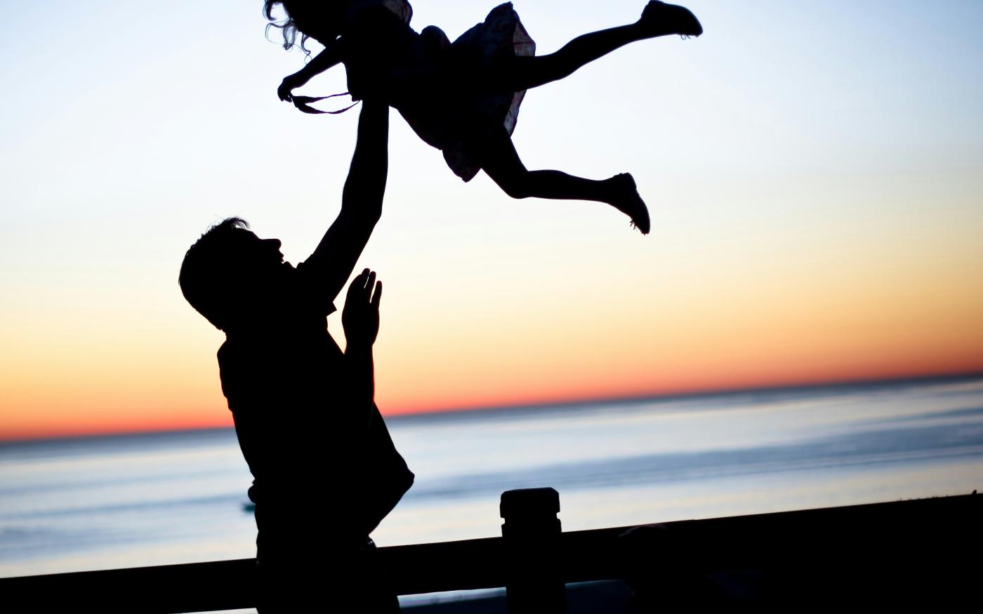 silhouette of man throwing girl in air by lauren lulu taylor courtesy of Unsplash.