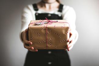 person showing brown gift box by Kira auf der Heide courtesy of Unsplash.