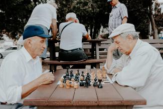 two men playing chess by Vlad Sargu courtesy of Unsplash.