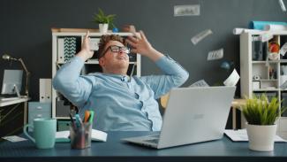 Man celebrating with money falling around him by Vitaly Gariev courtesy of Unsplash.