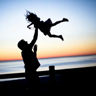 silhouette of man throwing girl in air by lauren lulu taylor courtesy of Unsplash.