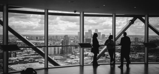 people standing inside city building by Charles Forerunner courtesy of Unsplash.
