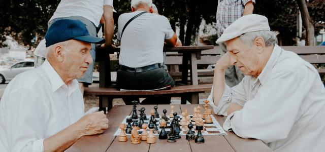 two men playing chess by Vlad Sargu courtesy of Unsplash.