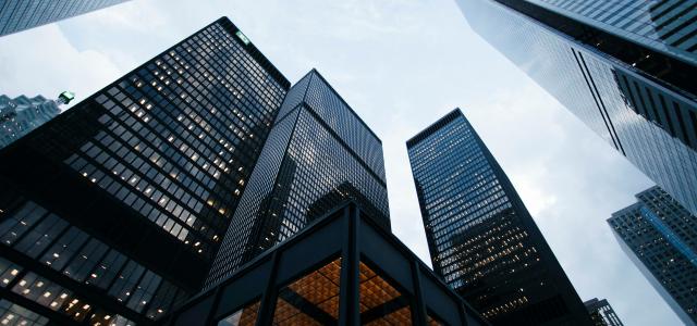 low angle photo of city high rise buildings during daytime by Sean Pollock courtesy of Unsplash.