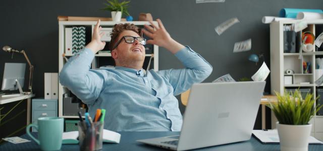 Man celebrating with money falling around him by Vitaly Gariev courtesy of Unsplash.